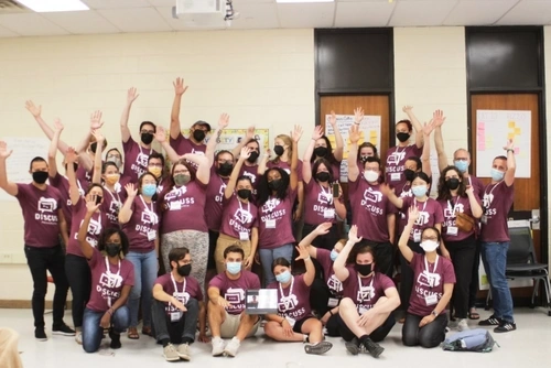 a group of social studies teachers raising their hands