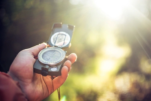 Stock image of a hand holding a compass