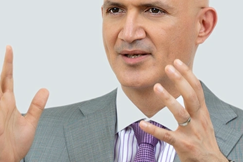 Headshot of Navin Valrani speaking with his hands