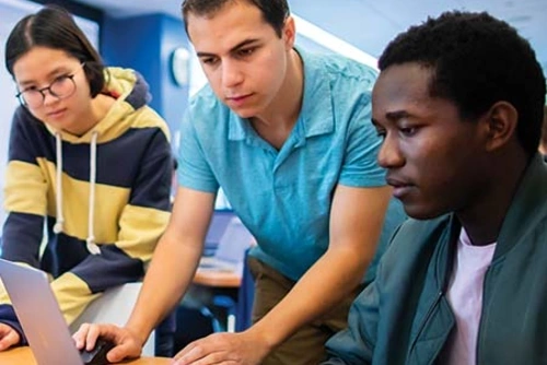 Students looking at a laptop