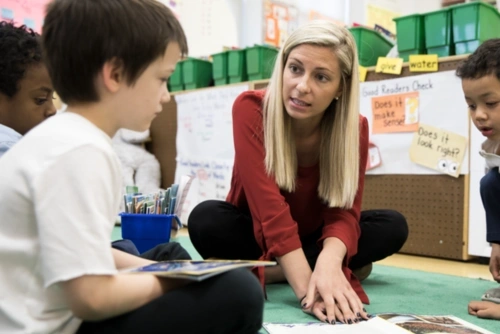 Teacher reading to a student