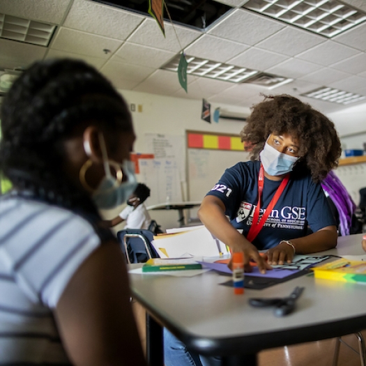 A teacher works with two students