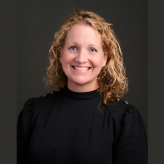 Janice Rafferty Grady  smiles at the camera wearing a black turtleneck