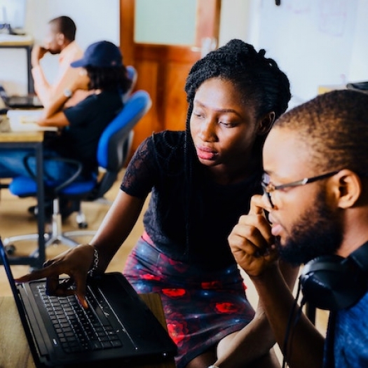 Two people looking at a computer screen.