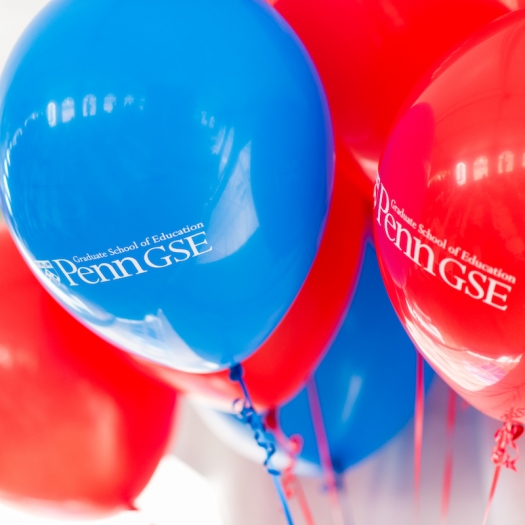 Red and blue balloons with Penn GSE logo