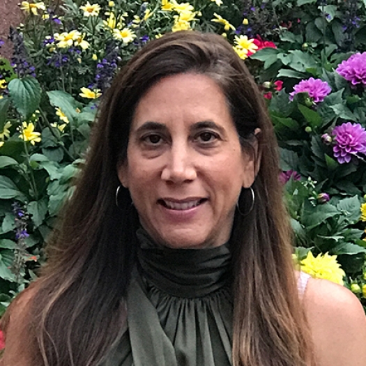 Woman smiling with background of flowers