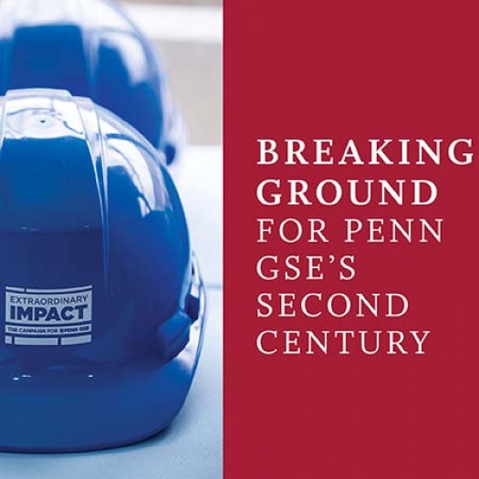 Shiny blue hardhats with the “Extraordinary Impact” logo sit on a table.