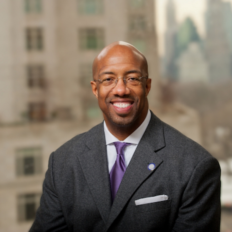 Bald man with glasses wearing suit.  