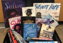 A selection of books from the 2019 Best Books list arranged in a suitcase