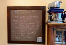 A family schedule written on a chalkboard. 