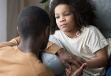 A parent compassionately talking to a small child.