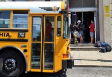 A school bus pulls up to a school. 