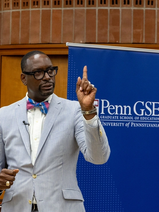 School Leadership alum and former Pennsylvania Secretary of Education Khalid Mumin speaks in front of a Penn GSE banner
