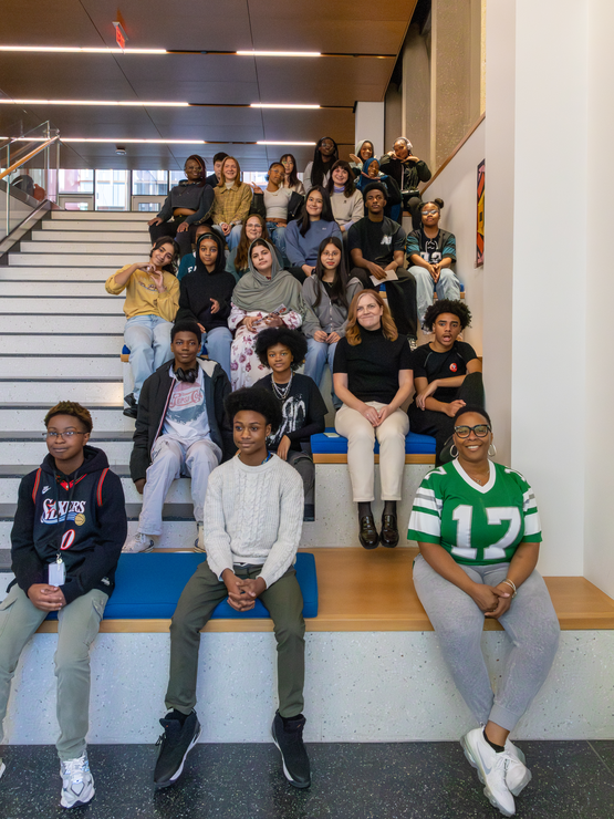 About 20 people, including SLA Beeber students, GSE students, and their teachers, sat on the steps in GSE's entryway together. 