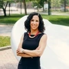 Dean Strunk poses in front of the button sculpture on Penn's campus