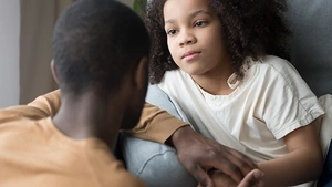 A parent compassionately talking to a small child.
