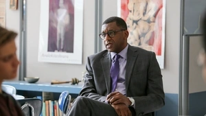 Howard Stevenson seated in front of a high school classroom, listening to one of the students off-camera sharing an experience.