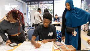Three students work together on a character map