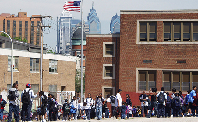 Students wait outside of their school.