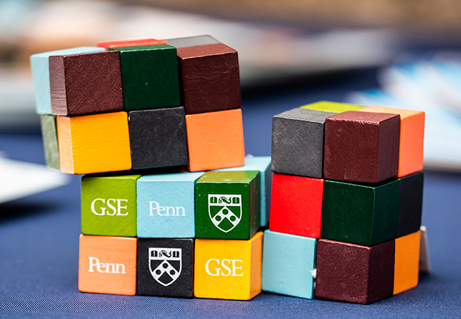 Colorful block puzzles with the words Penn GSE and the Penn shield on them are sitting on a table