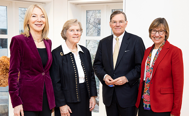President Amy Gutmann, Dean Grossman, and members of the McGraw family stand together smiling at the camera.
