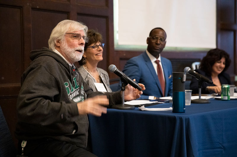 Four people present on a speaker panel