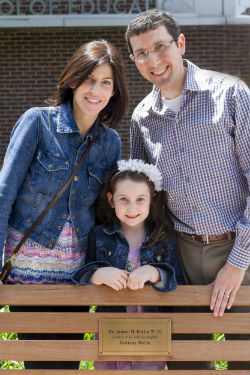  Photo caption: Josh (right), along with his wife, Michele (left), and daughter, Brittany (center), visit the bench in front of Penn GSE that Josh donated “in honor of his amazing daughter Brittany Berlin.”