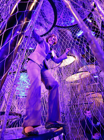 Female superintendent climbing rope exhibit